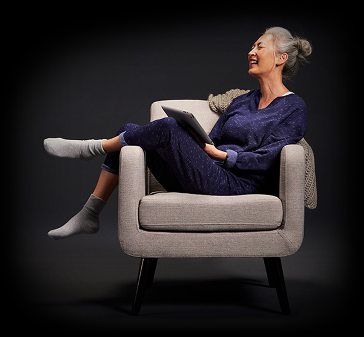person in armchair laughing