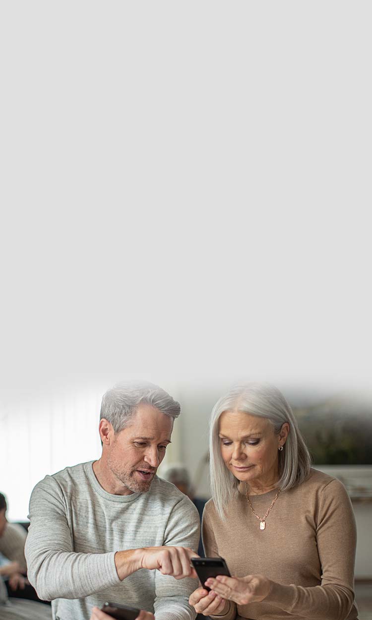 Man and woman looking at phone screens